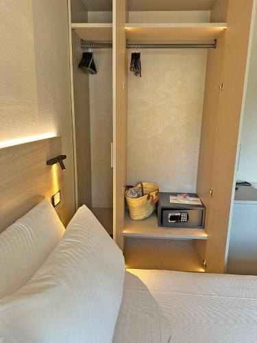 a bedroom with a bed and a radio on a shelf at Cloud Nine in Riomaggiore