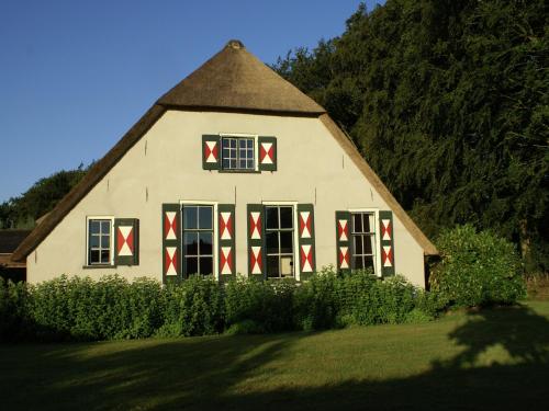 a large white house with red crosses on the windows at Peaceful Farmhouse in Doorn near Forest in Doorn