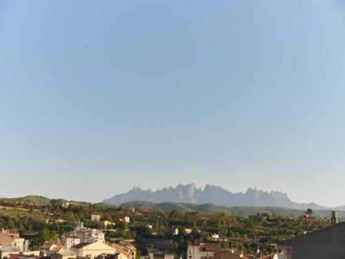 a view of a city with mountains in the distance at 17th century farmhouse in Bages near Montserrat in Castellfullit del Boix