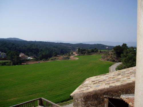 a view of a green field from a building at 17th century farmhouse in Bages near Montserrat in Castellfullit del Boix
