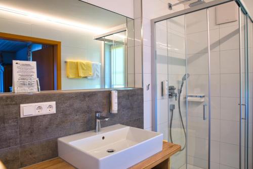 a bathroom with a sink and a shower at Landhotel Schellenberg in Überlingen