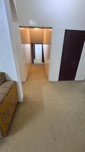 a hallway with a room with a couch and a hallwayngthngthngthngthngth at جوهرة الاشخرة in Al Ashkharah