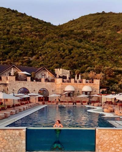 a person in a swimming pool at a resort at Chateau Fasel in Tirana