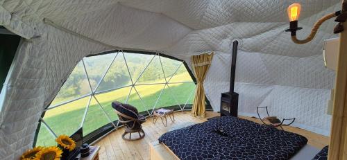 a room with a tent with a large window at GLAMPING Považie in Trenčín