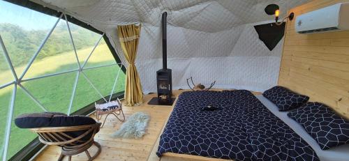 a room with a bed in a tent at GLAMPING Považie in Trenčín