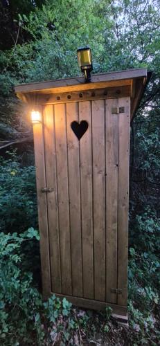 a out house with a heart on the door at GLAMPING Považie in Trenčín