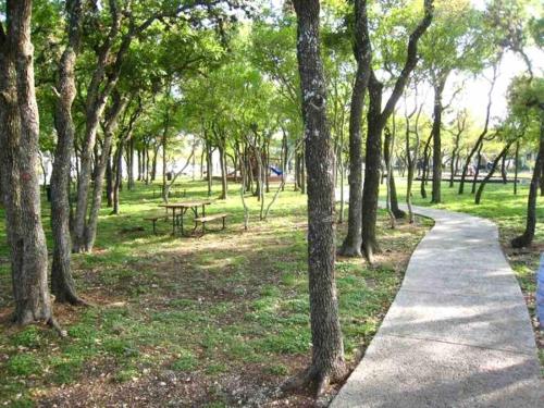 a path in a park with a picnic table and trees at Witte Wonderland - Separate Garage Apartment!! in Kyle