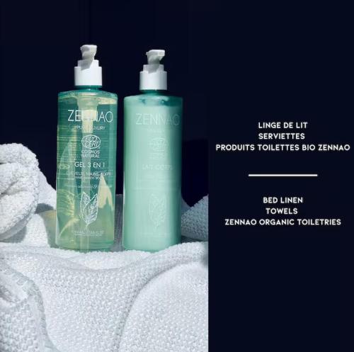 two bottles of detergent sitting on top of towels at Galerie d'art Nakai - Hyper Center - By Primo in Tournus