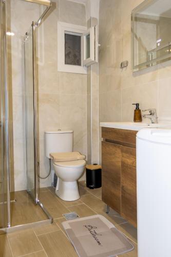 a bathroom with a toilet and a sink and a shower at Modern House Close to the Sea Asprovalta in Asprovalta