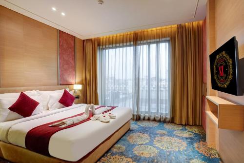 a hotel room with two beds and a large window at SANDOZ Pribson Hotel near Golden Temple in Amritsar
