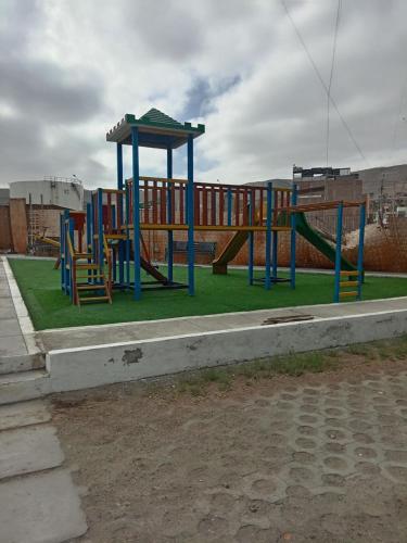 a playground with slides and a play structure at Dpto Amoblado ILO-PERU in Ilo