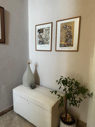 a table with a vase on it next to a plant at Stella's Home in Čitluk