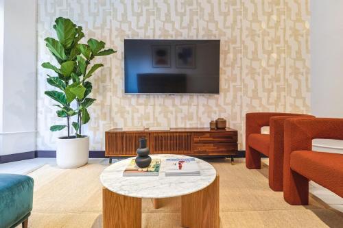 a living room with a tv and a coffee table at Stunning 1 BDR 1 BTH Modern Loft with Pool, Jacuzzi in DTLA! in Los Angeles