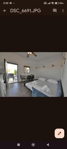a picture of a bedroom with a bed and a table at kleris apartment 11 in Tinos