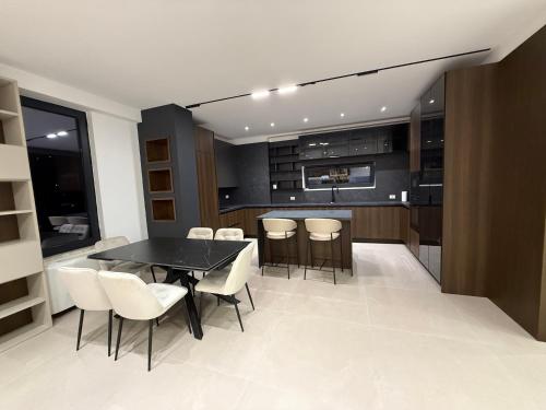 a kitchen with a table and chairs and a counter at BelVilla in Lalzit Bay