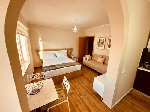 a small room with a bed and a couch at Holiday Home Lezha 2 in Lezhë
