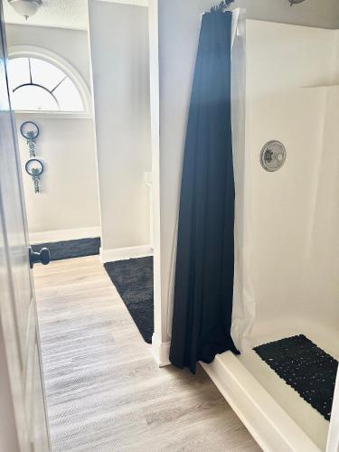 a door leading into a hallway with a blue curtain at King Suite - Private Bath - Gym - Hot Tub - Game Room in Ellenwood