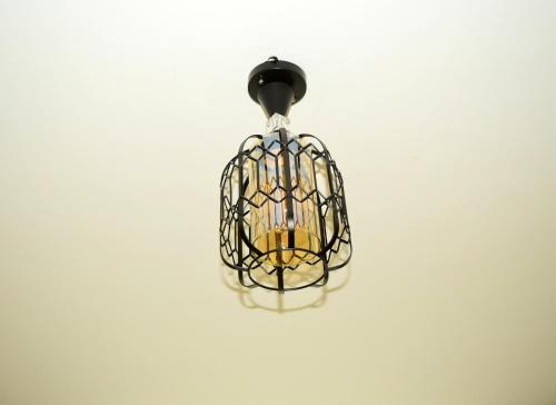 een kooilamp die aan een witte muur hangt bij Executive homes in Kitengela 