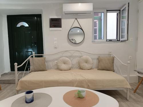 a bedroom with a bed with a table and a mirror at LA CASA Di GIORGIO in Pentati