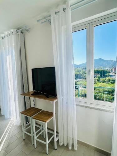 a television sitting on a table in front of a window at Casa Sbollazza con parcheggio e vicino al parco in Sestri Levante