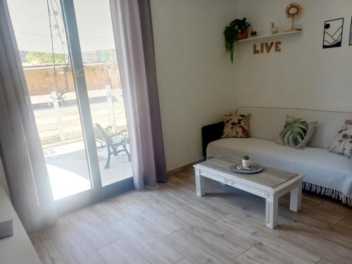 a living room with a couch and a table at Cal Hidalgo in Palouet