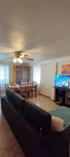 a living room with a couch and a flat screen tv at Casa do Carvoeiro in Fundão