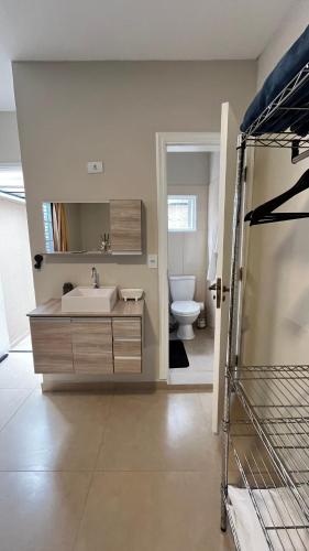 a bathroom with a sink and a toilet at Casa Rosário Centro de Amparo in Amparo
