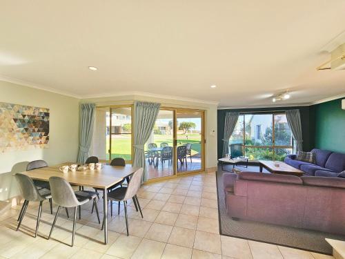 a living room with a table and a couch at Pelican Shore Villa 22 - Kalbarri WA in Kalbarri