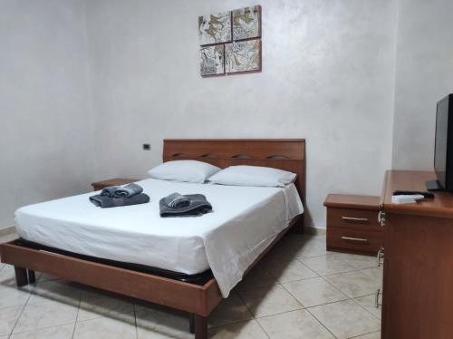 a bedroom with a bed and a desk and a television at Casa Leblanc in Civitavecchia