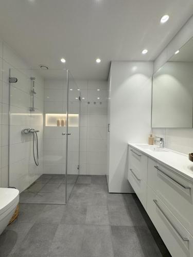 a bathroom with a shower and a toilet and a sink at Casa Cimili City in Kristiansand