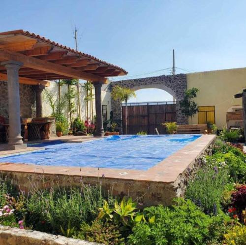 a swimming pool in the backyard of a house at Casa de Campo luciérnaga in San Miguel de Allende