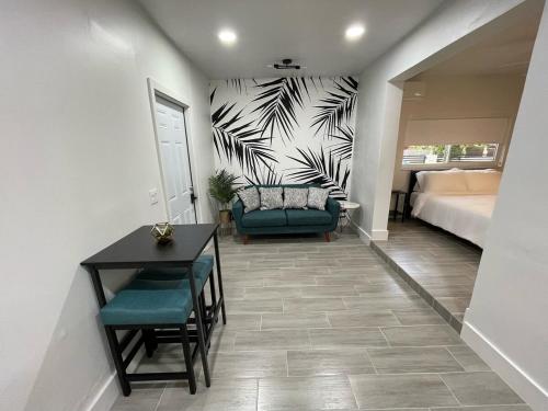 a room with a bed and a table and a couch at The Vice City Suite - Private stay with Free Parking in the Heart of Miami in Miami