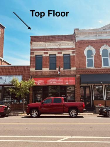 a red truck parked in front of a building at Gorgeous apartment across from La Crosse Center in La Crosse