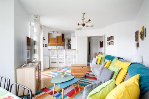 a living room with a couch and a table at La Défense wonderful 2 bedrooms apartment in Suresnes