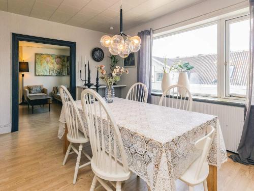 a dining room with a table and white chairs at 5 person holiday home in Snedsted in Snedsted