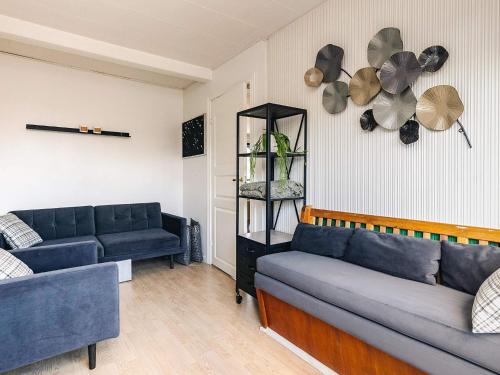 a living room with two blue couches and a shelf at 5 person holiday home in Snedsted in Snedsted