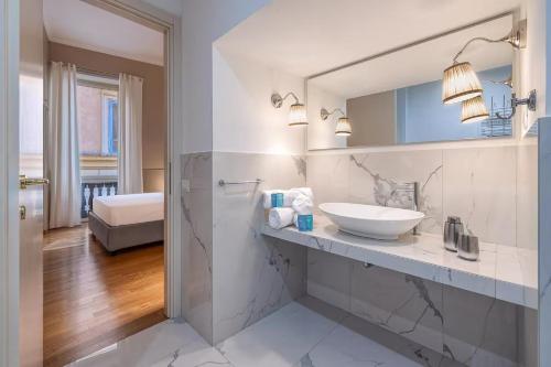 a white bathroom with a sink and a mirror at Navona Boutique House in Rome