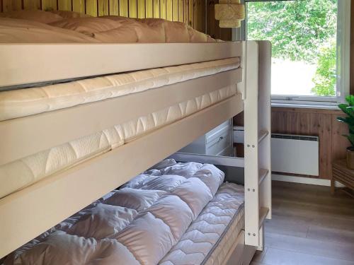 a bunk bed with pillows on it in a room at Spacious Lakeside Retreat in Ansager