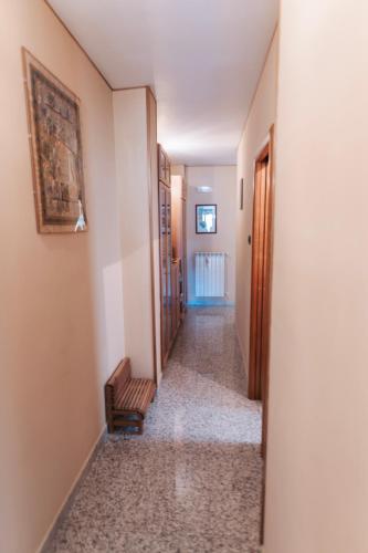 a hallway with a stairway with a chair in a room at Al Civico Centocinquantasei in Latiano