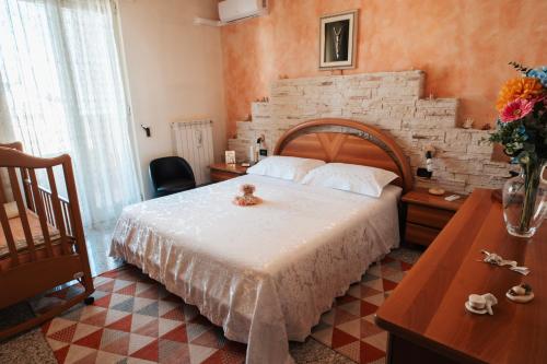 a bedroom with a bed with a teddy bear on it at Al Civico Centocinquantasei in Latiano