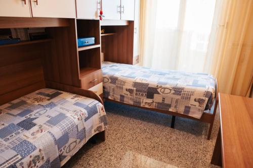 a hotel room with two beds and a table at Al Civico Centocinquantasei in Latiano