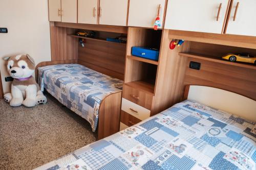 a bedroom with two twin beds and a stuffed animal at Al Civico Centocinquantasei in Latiano