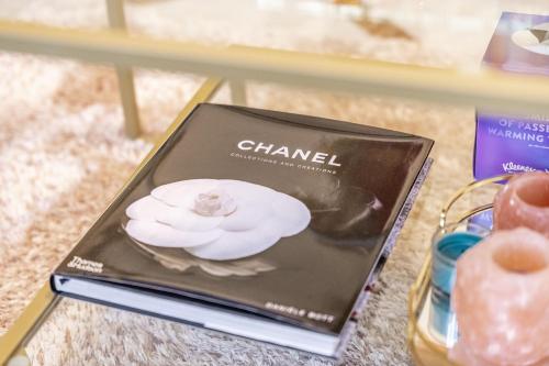 a book on a table with a flower on it at Chingford Manor in Chingford