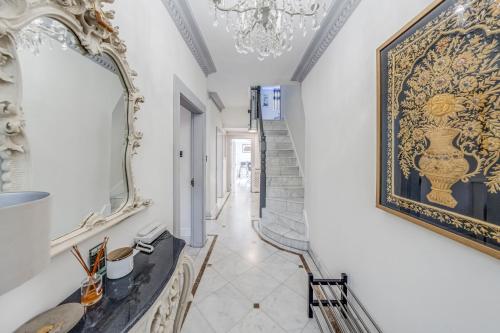 a hallway with a mirror on the wall and a table at Chingford Manor in Chingford