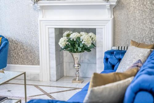 a vase of white flowers sitting in a fireplace at Chingford Manor in Chingford