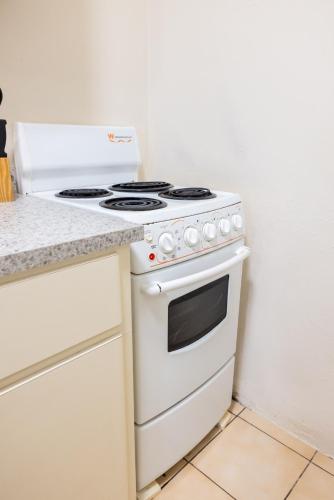 a white stove top oven sitting in a kitchen at Beach Apartment C3 Montones in Jobos
