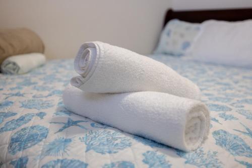 a stack of towels sitting on a bed at Beach Apartment C3 Montones in Jobos