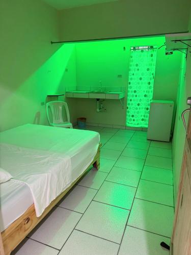a hospital room with a bed and a green light at Miami Studios DR in Santo Domingo