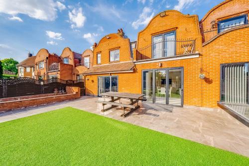 a large brick building with a bench in front of it at Chingford Manor in Chingford