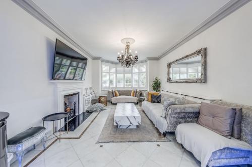 a living room with a couch and a fireplace at Chingford Manor in Chingford